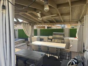 a kitchen with a table and chairs and a grill at Homes by Abby LLC in Maricopa