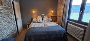 a bedroom with a bed with a large window at Apartmenthaus Hinterer in Bad Goisern +88 photos