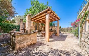 an outdoor kitchen with a wooden pavilion in a yard at Moli Den Guixo in Artá +39 photos