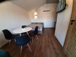 a small room with a table and chairs and a bed at Apartament 12 in Zwardoń