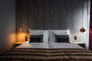 a bedroom with a large bed with two pillows at KUST Hotell & SPA in Piteå