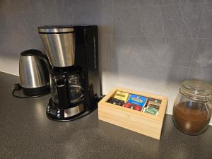 a coffee maker sitting on a counter next to a box at Leilighet Vingnes in Lillehammer