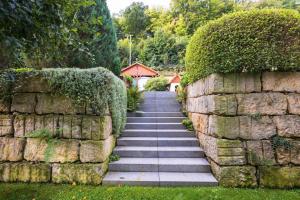 a stone wall with a staircase next to a stone wall at Elbvilla Pirna mit Sauna und Kamin mit privatem Zugang zur Elbe in Pirna