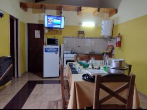a kitchen with a table and a counter top at Cabañas Los Dos Talas in Barrio Parque El Corcovado