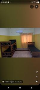 two bunk beds in a room with green walls at Cabañas Los Dos Talas in Barrio Parque El Corcovado