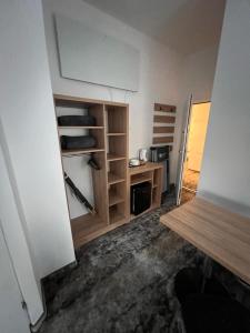 a room with a closet with a desk and shelves at HORIZON in Ustka