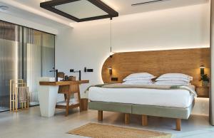 a bedroom with a bed with a wooden headboard at Diastar Luxury Suites NEW in Heraklio