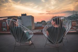 two people sitting in chairs on a roof at Co404 Oaxaca - Coliving Coworking in Oaxaca City