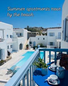 a balcony with a table with cups and saucers on it at Mimoza Collection suites in Ornos