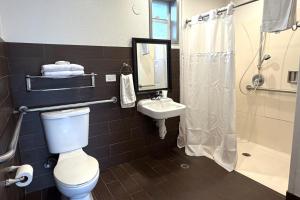 a bathroom with a toilet and a sink and a shower at 6 Rivers Motel Fortuna near Hwy 101 in Fortuna +18 photos