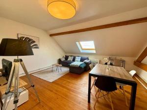a living room with a couch and a table at Sweet Harmonie in Grand-Fort-Philippe
