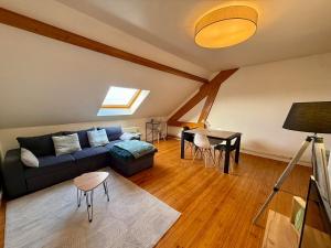 a living room with a couch and a table at Sweet Harmonie in Grand-Fort-Philippe