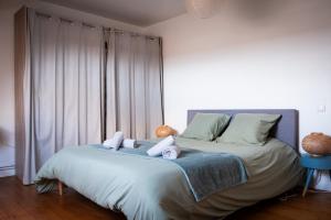 a bedroom with a bed with towels on it at Sweet Harmonie in Grand-Fort-Philippe