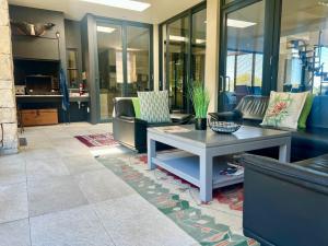 a living room with a coffee table and chairs at House Vos in Hermanus
