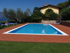 a swimming pool in a yard next to a house at Casa Pagani in Brenzone sul Garda +16 photos