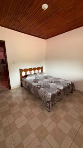 a bedroom with a bed in a room at Cantinho da Nara em Ibitipoca in Conceição da Ibitipoca +2 photos