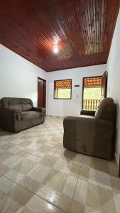 a living room with two couches and a wooden ceiling at Cantinho da Nara em Ibitipoca in Conceição da Ibitipoca