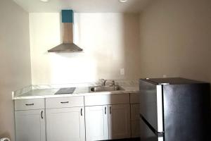 a kitchen with a sink and a refrigerator at 6 Rivers Motel Fortuna near Hwy 101 in Fortuna