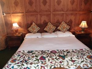 a bedroom with a bed with a white bedspread at Heevan in Srinagar