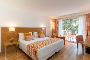 a hotel room with a bed and a balcony at Hesperia Mallorca in Palma de Mallorca +67 photos