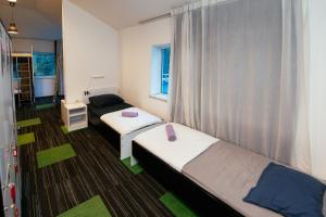 a small room with two beds and a window at Hostel 365 For U in Dubrovnik