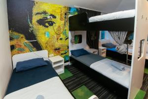 a bedroom with two bunk beds and a mural at Hostel 365 For U in Dubrovnik