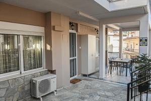 a balcony of a house with a table and chairs at Soula's Traditional House in Kalabaka