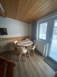 a room with a table and chairs and a window at Penzion OK in Svoboda nad Úpou