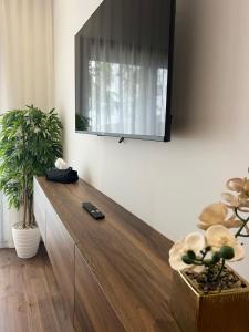 a living room with a tv on the wall at A Suites in Casablanca
