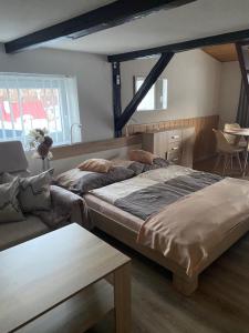 a bedroom with a large bed and a couch at Penzion OK in Svoboda nad Úpou +56 photos