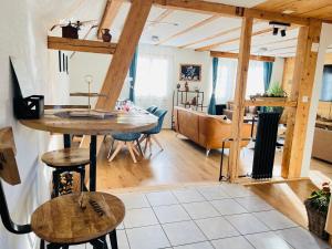 a kitchen and living room with a table and chairs at Chalet Alpine in Kandersteg
