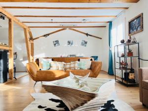 a living room with a couch and a table at Chalet Alpine in Kandersteg