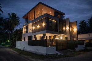 a house with lights on top of it at night at Sharvin Villa in Karaikal