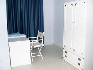 a room with a desk and a chair and a window at La Pergola Bilocale 6 - Cavo in Cavo +8 photos
