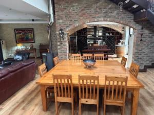 a dining room with a wooden table and chairs at 20 at Meul in Potchefstroom