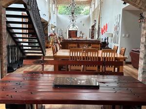 a dining room with wooden tables and chairs and a staircase at 20 at Meul in Potchefstroom +30 photos