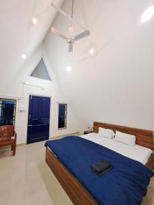 a bedroom with a bed and a ceiling fan at Mung Kham Stays in Jorhat
