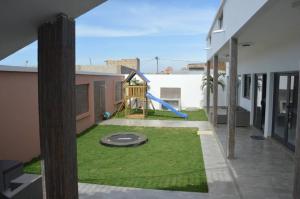 a small yard with a playground in a house at Villa Keur Carla in Niangol