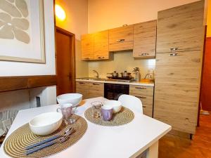 a kitchen with a white table with two dishes on it at La Maison Pilly in Sondalo