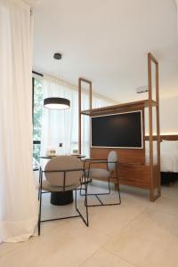 a dining room with a tv and a table and chairs at Aira Apart Hotel Boutique in Buenos Aires