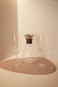 two wine glasses and a vase on a shelf at Aira Apart Hotel Boutique in Buenos Aires +55 photos