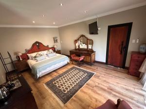 a bedroom with a bed and a dresser and a mirror at 20 at Meul in Potchefstroom