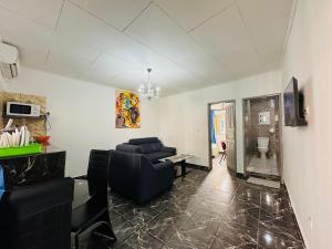 a living room with a couch and a table at CAMERHOME "Low Cost" in Douala