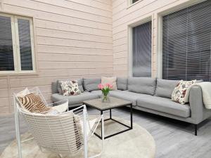 a patio with a couch and a table and chairs at Villa Taipale - 10hlö, Himosranta in Jämsä