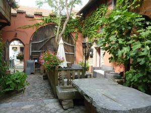 a patio with a table and chairs and a building at Chez Norbert in Bergheim +5 photos