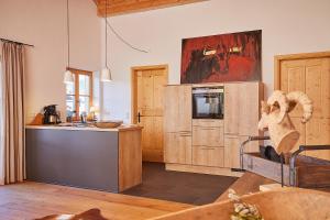 a kitchen with a counter top and a microwave at Landhauswohnung Dosbach in Reit im Winkl +1 photo
