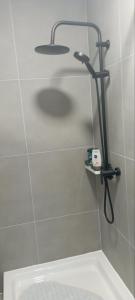 a shower in a bathroom with a shower head at LevelUP in Đakovo