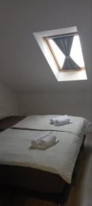 a bedroom with a bed with two towels on it at LevelUP in Đakovo