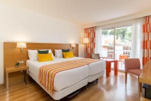 a hotel room with a bed and a balcony at Hesperia Mallorca in Palma de Mallorca