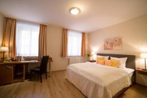 Postel nebo postele na pokoji v ubytování Boardinghouse Pfarrkirchen